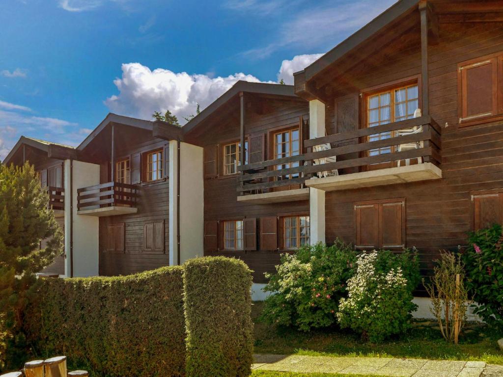 a house with a fence in front of it at Chalet Chalets Tsamandon by Interhome in Nendaz