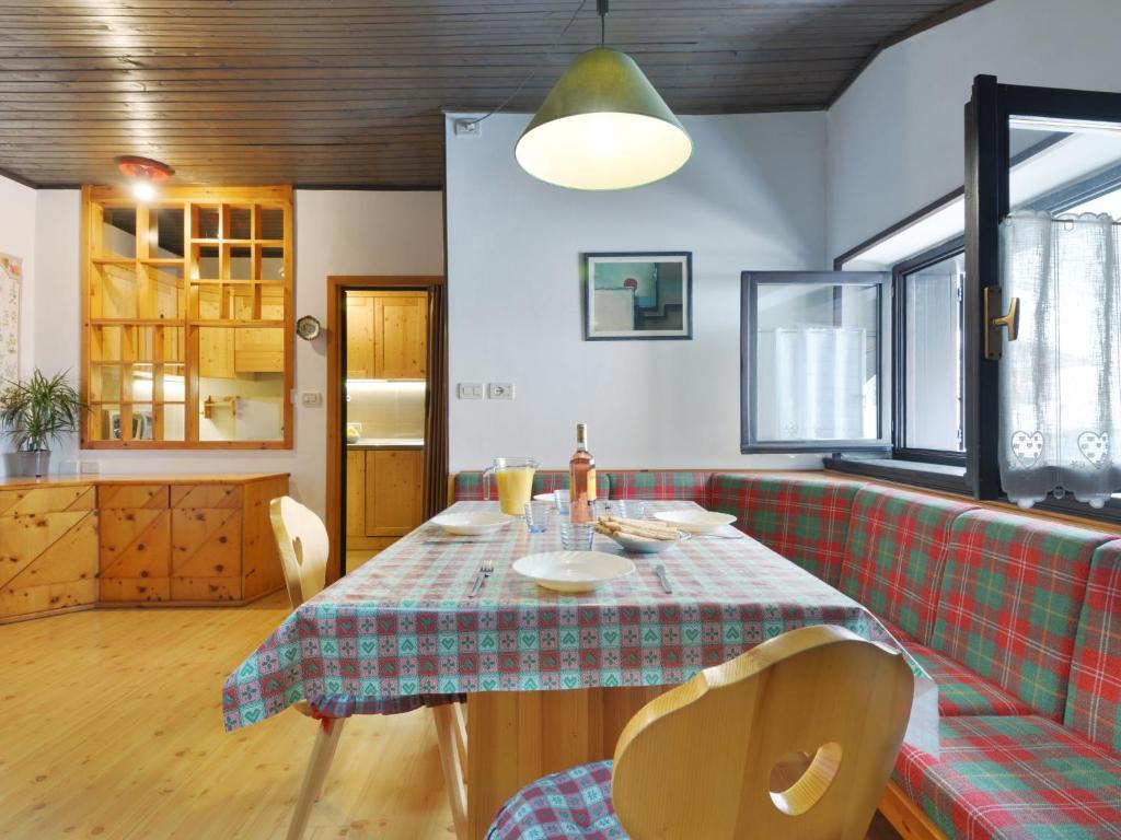 a dining room with a table and a couch at Apartment Apt 47 by Interhome in Alba di Canazei