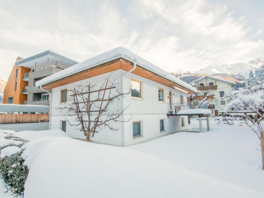 a house in the snow with snow at Apartment Christine by Interhome in Prutz