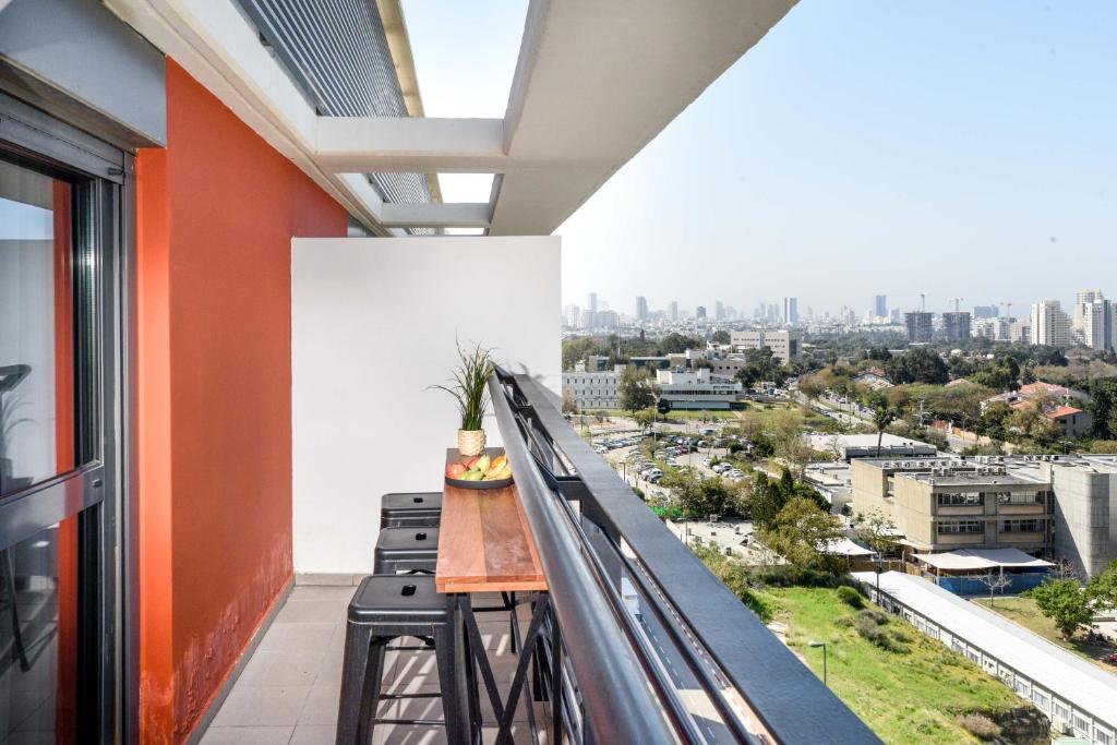 a balcony with a view of the city at דירות גני תערוכה - TLV university apartments near Expo by Sea N' Rent in Tel Aviv