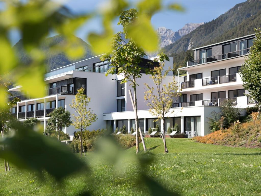 an exterior view of a building with mountains in the background at Apartment Oberhofer-5 by Interhome in Telfes im Stubai