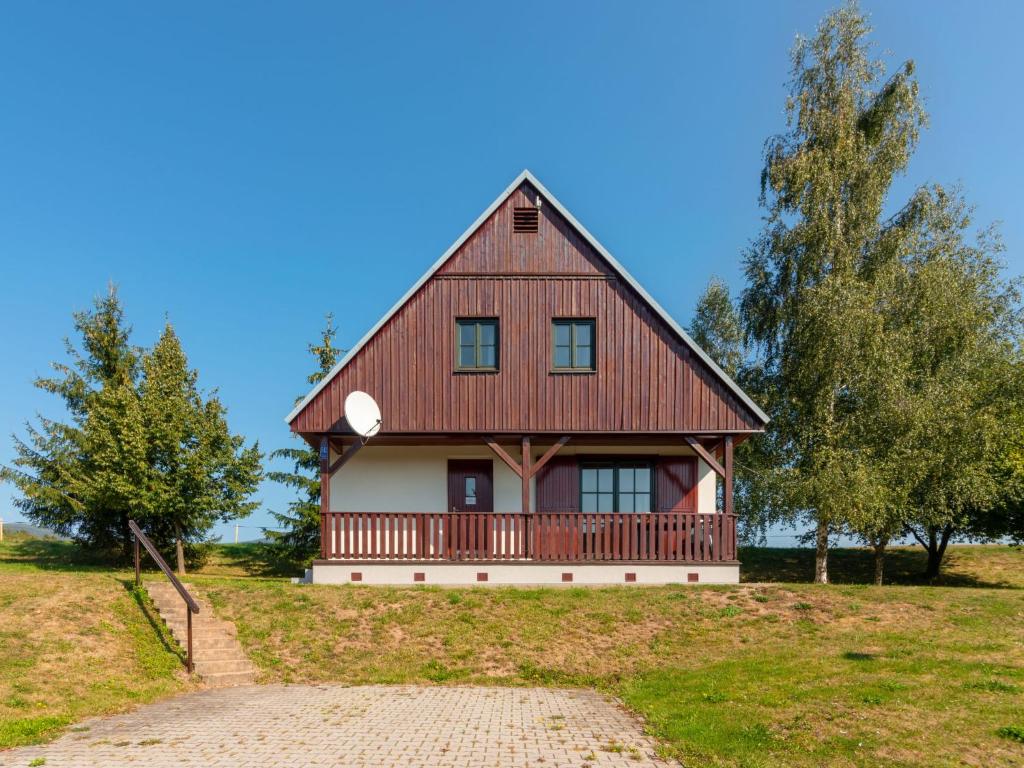 a large wooden house on a hill with trees at Holiday Home Holiday Hill 62 by Interhome in Lauterwasser