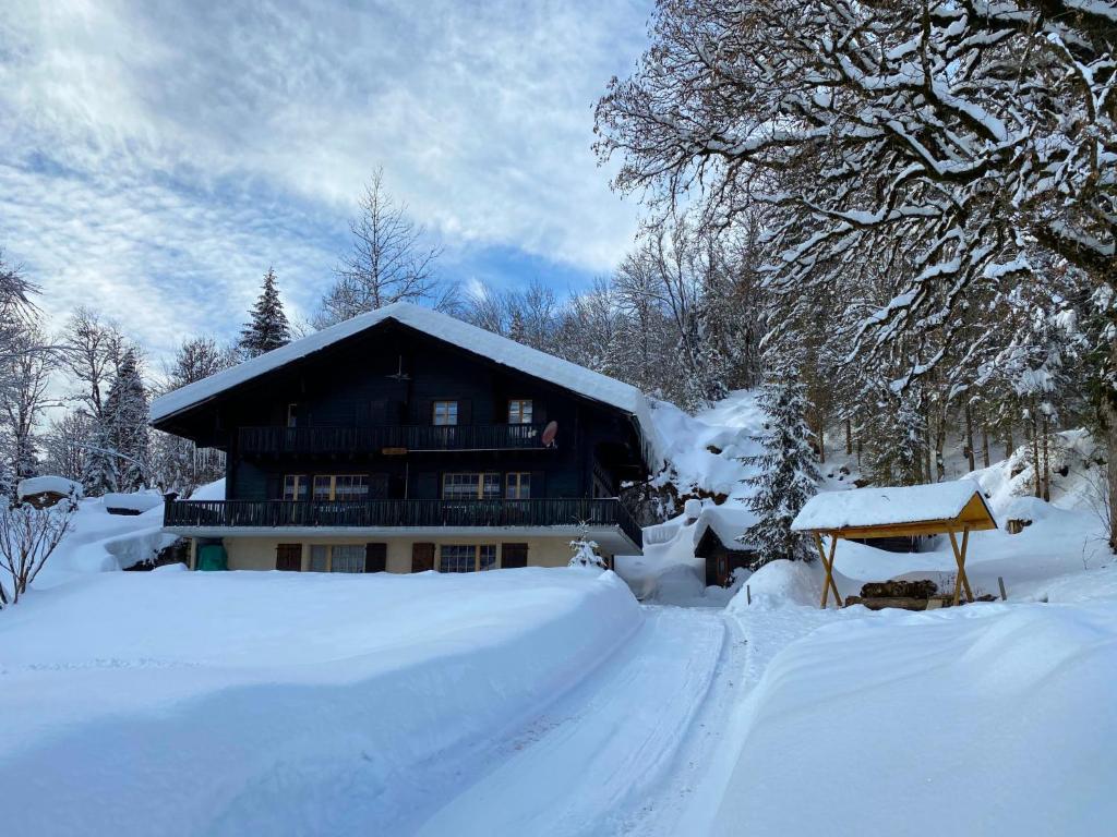 a house covered in snow in front at Apartment Chalet L'Aube by Interhome in Vers L'Eglise