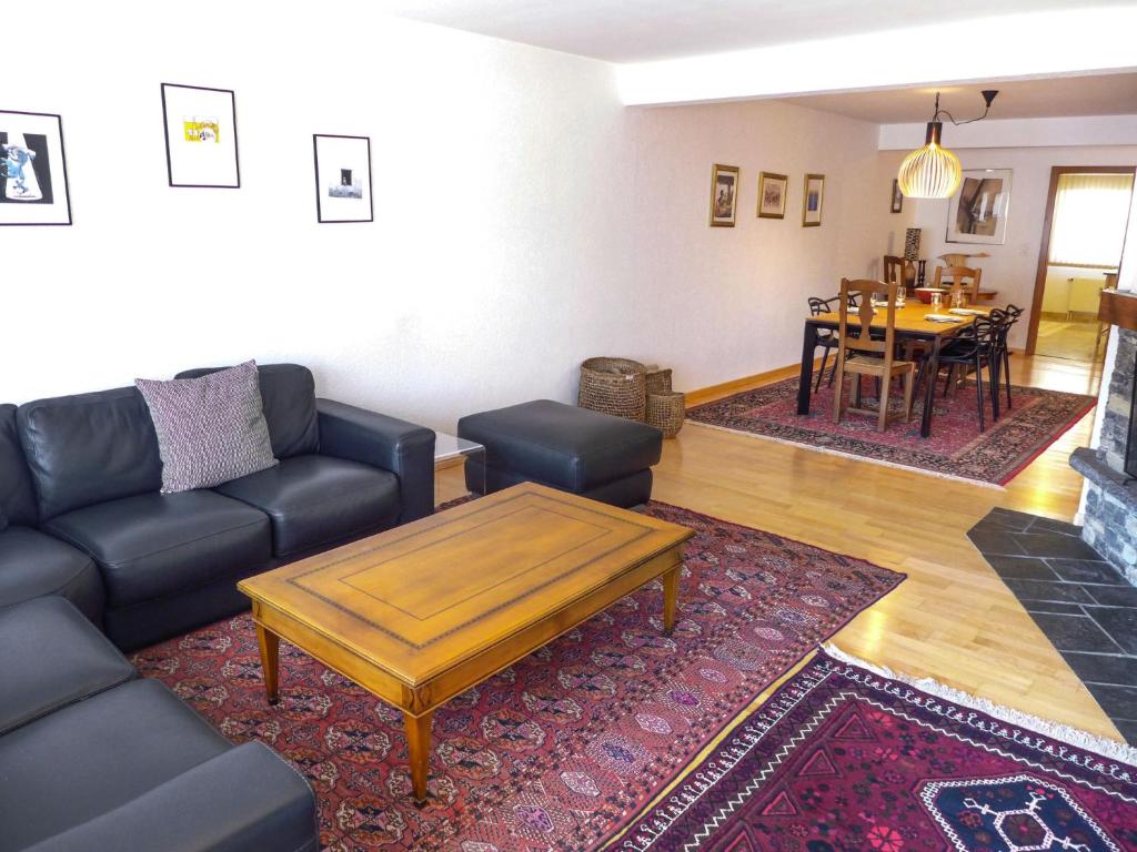 een woonkamer met een bank en een salontafel bij Apartment Miremont A-B-C-4 by Interhome in Crans-Montana