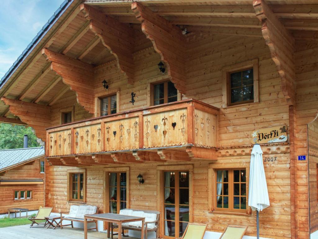 a log cabin with a balcony on top of it at Chalet Dörfli by Interhome in Les Diablerets