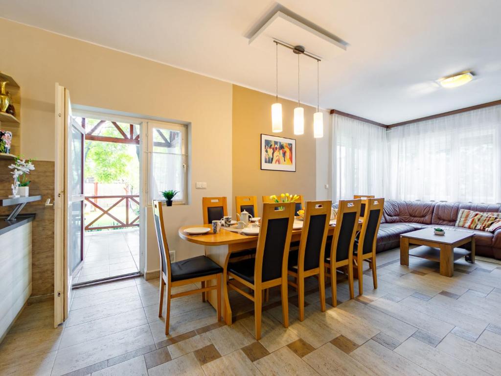 jadalnia i salon ze stołem i krzesłami w obiekcie Holiday Home Marian by Interhome w mieście Balatonboglár