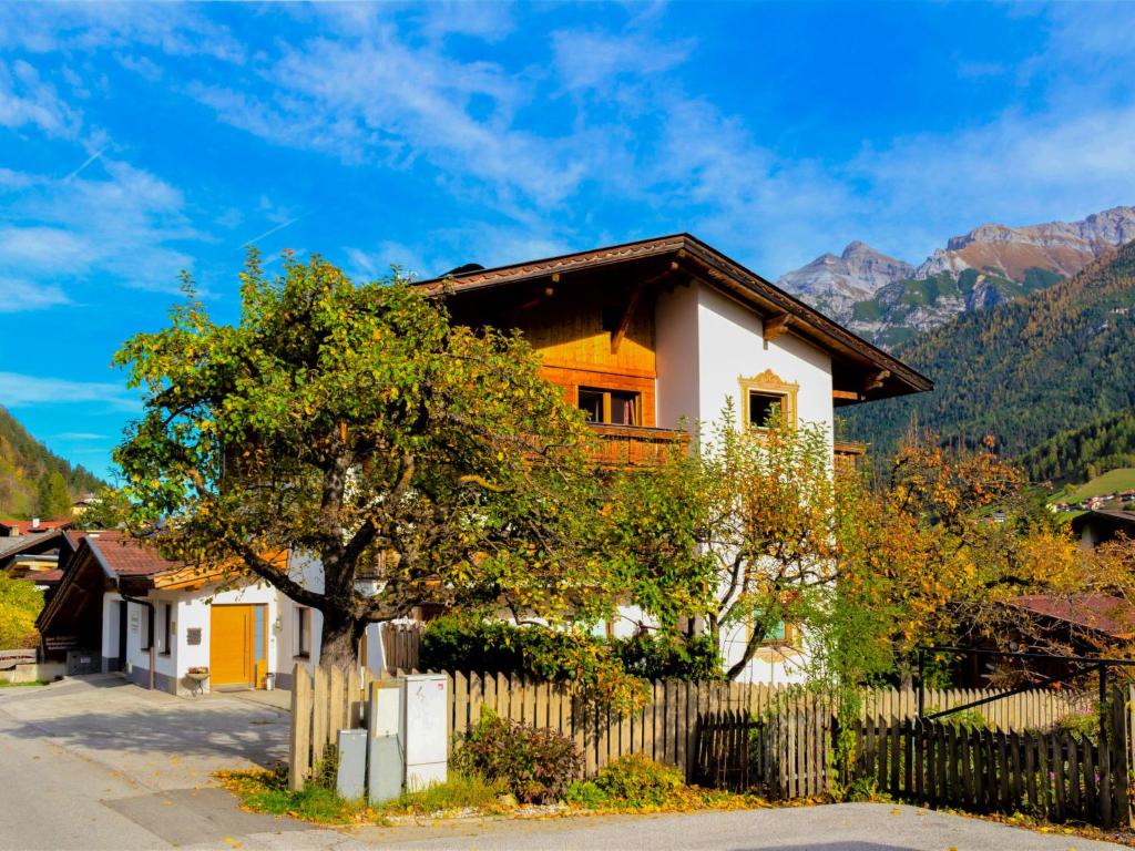 a house with a fence and a tree at Apartment Anna by Interhome in Neustift im Stubaital