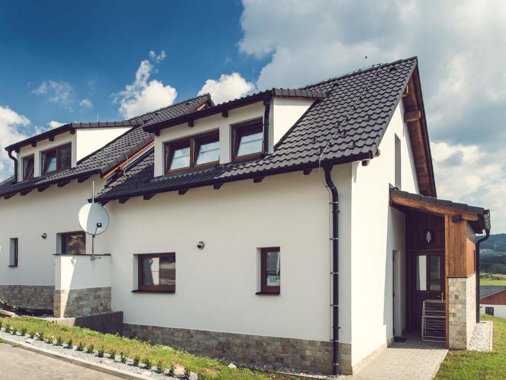 a white house with a black roof at Holiday Home Residence Lipno-2 by Interhome in Lipno nad Vltavou