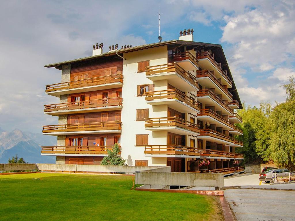 a large building with balconies on the side of it at Apartment Derborence 28 by Interhome in Nendaz