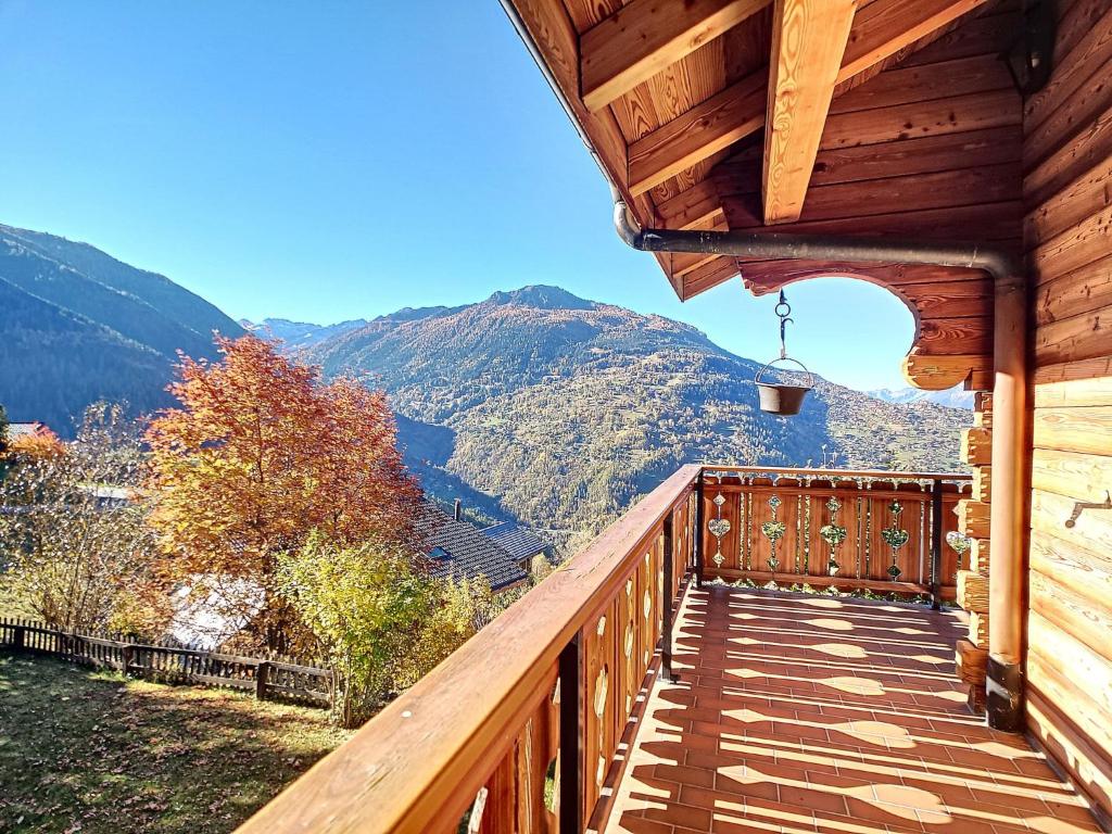 a wooden balcony with a view of a mountain at Chalet Les 4 Saisons by Interhome in Veysonnaz