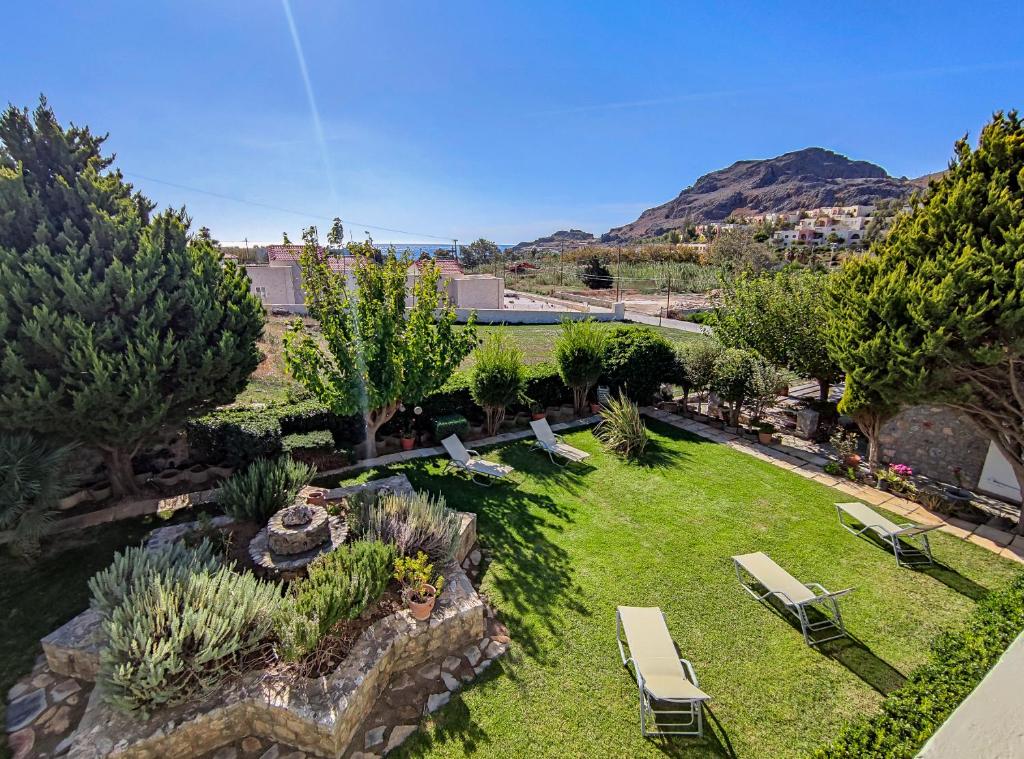 an aerial view of a garden with chairs and trees at Mythos Apartments in Damnoni
