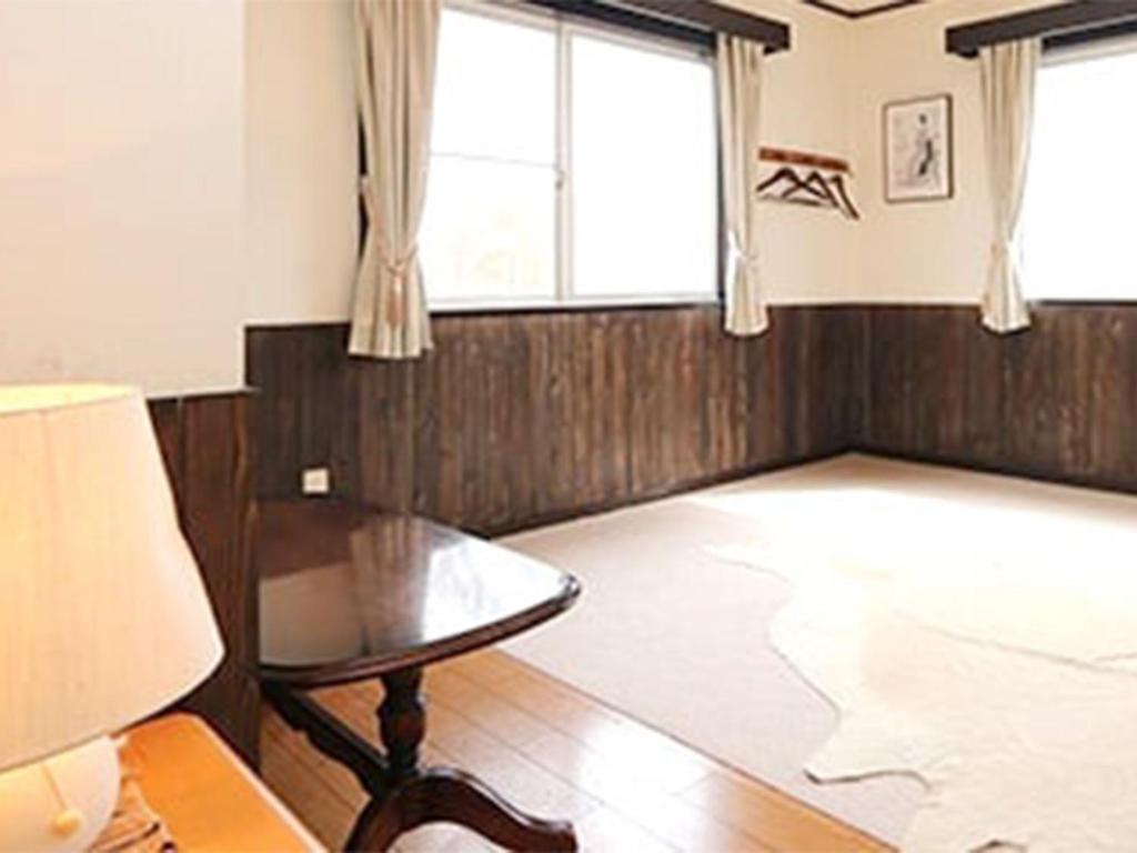 a living room with a table and a window at Blanche Mori - Vacation STAY 86844v in Hokuto