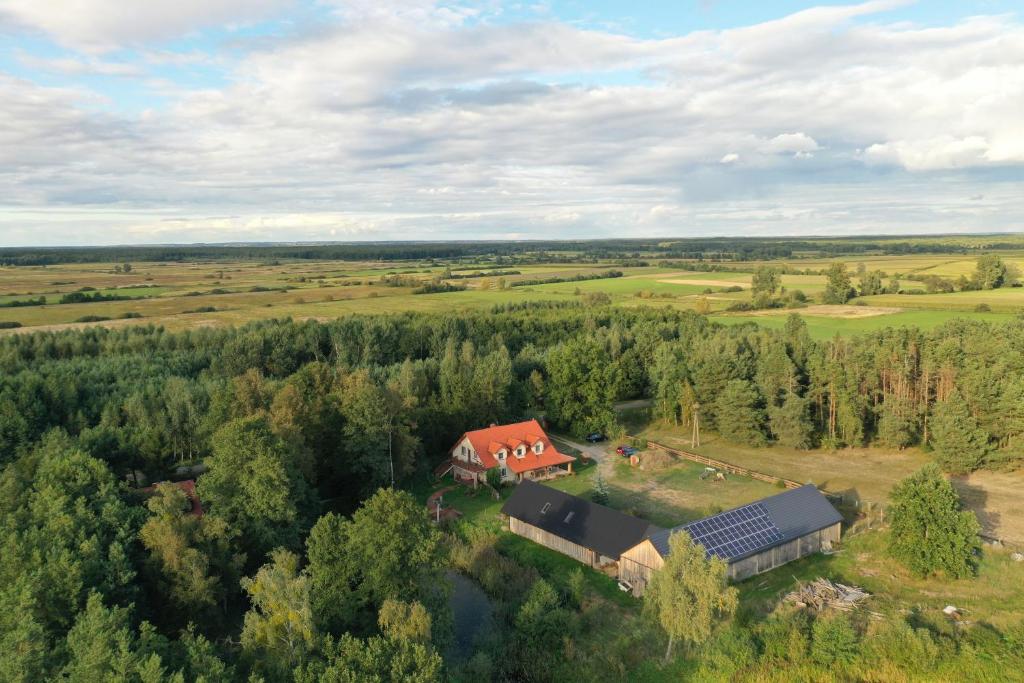 an aerial view of a farm with a house and a barn at Rajski Staw in Zajki