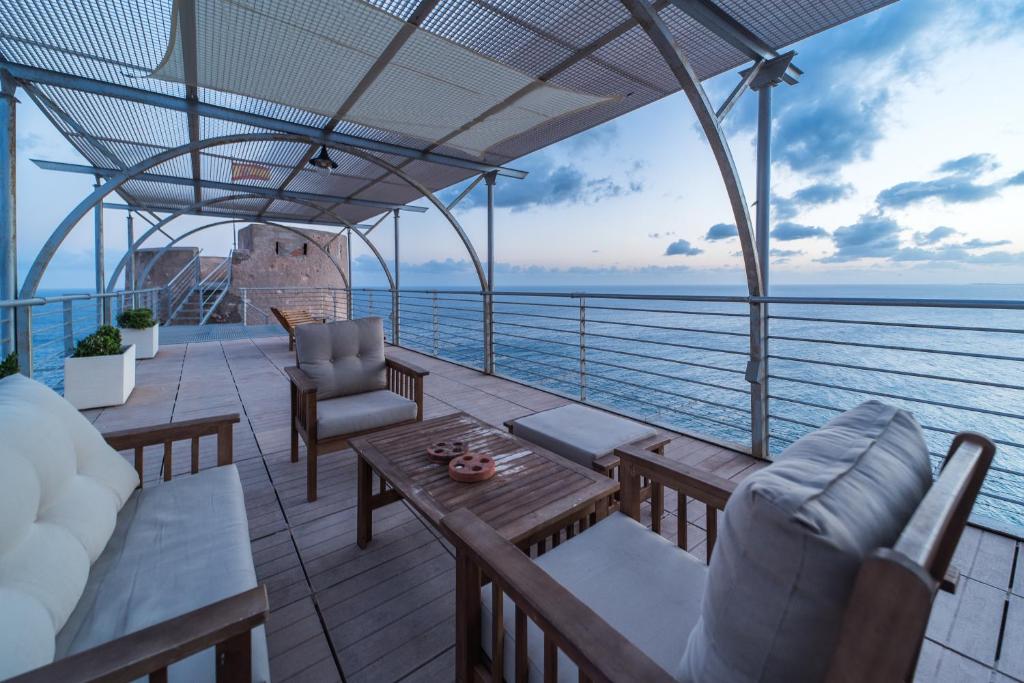 a balcony with furniture and a view of the ocean at Mirador Torre de la Garrofa in Almería