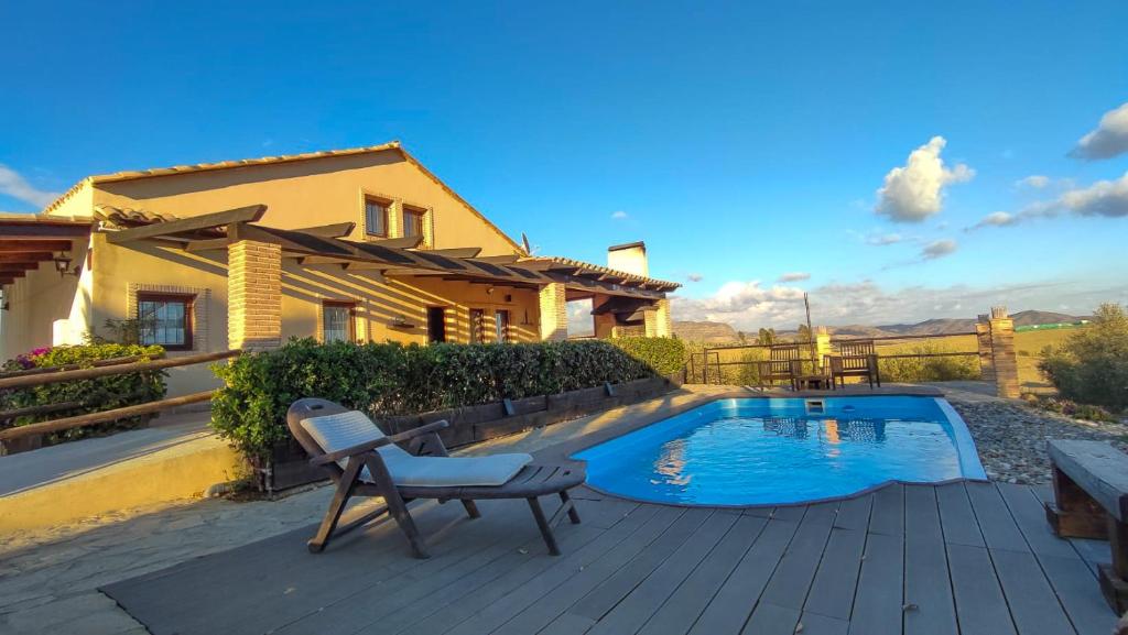 a patio with a chair and a swimming pool at Victoria & Olivar in Málaga