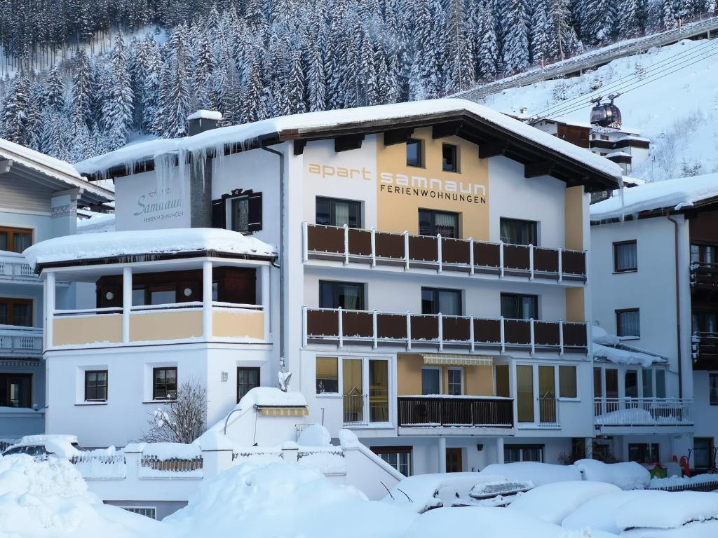 a hotel in the snow with snow covered buildings at Apart Samnaun in Ischgl