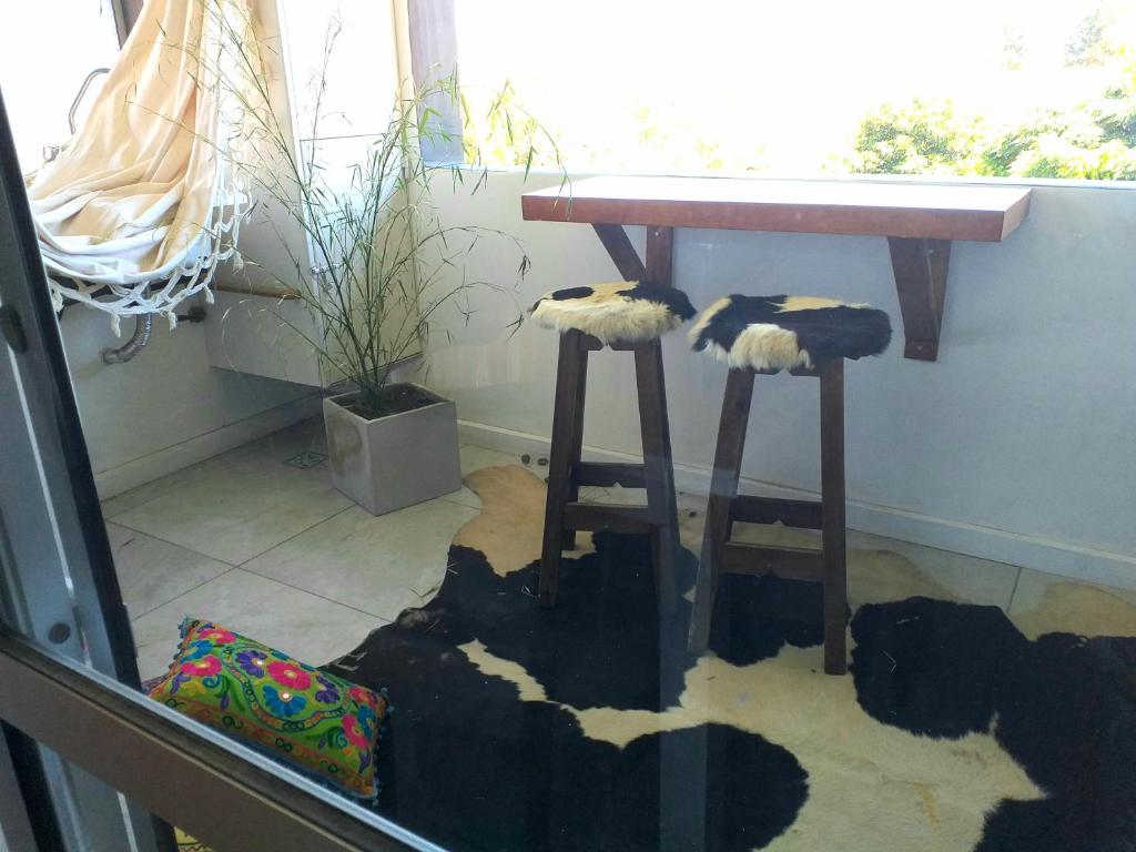 a table and two stools in front of a table at Apartamentos "Rufina II y III Merlo céntrico in Merlo