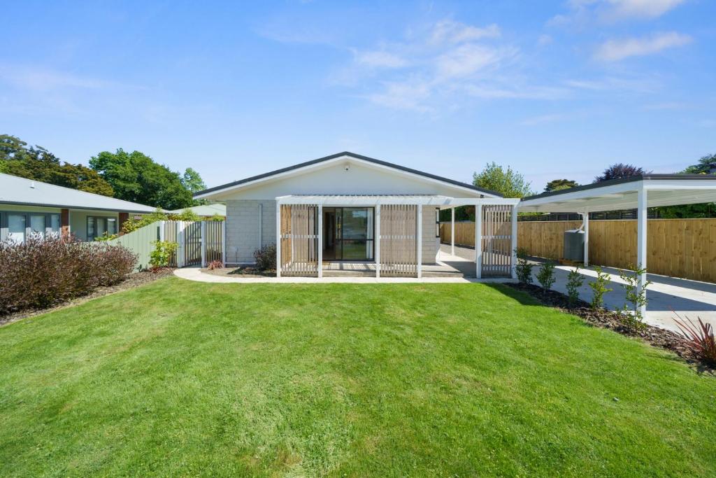 a house with a green lawn in the yard at Greytown Getaway - Greytown Holiday Home in Greytown