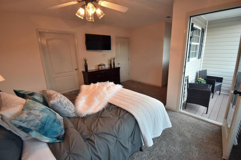 a living room with a couch with a blanket on it at Cozy Renovated Winder Townhouse in Winder