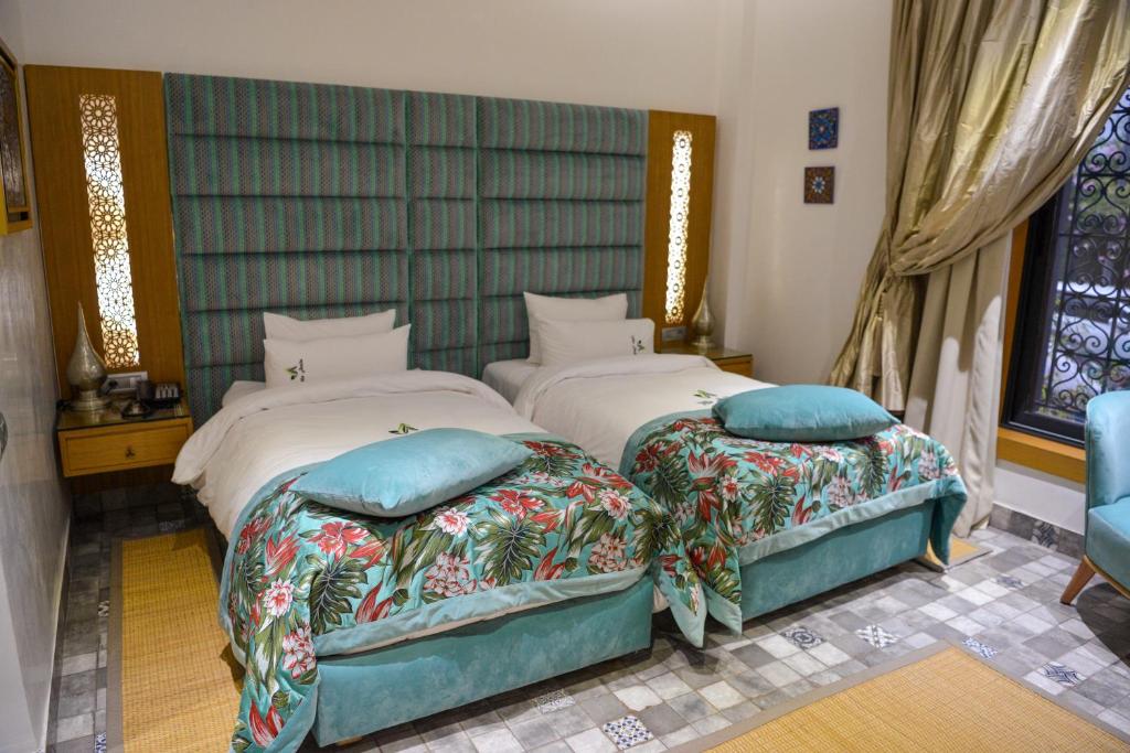 Postel nebo postele na pokoji v ubytování Aralia Boutique Hôtel