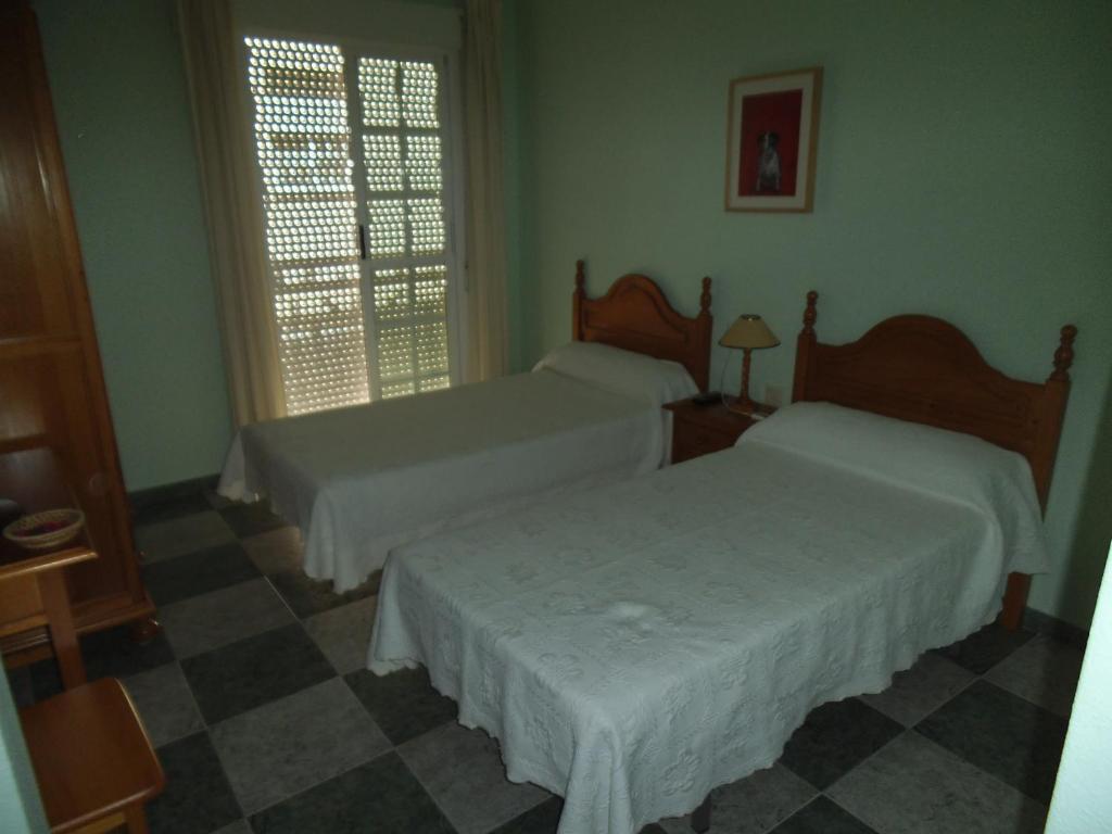 En eller flere senge i et værelse på Hostal San Andres