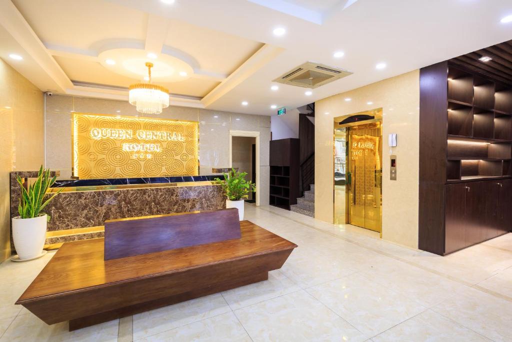 a lobby of a hotel with a sign on the wall at Queen Central Hotel - Ben Thanh Market in Ho Chi Minh City