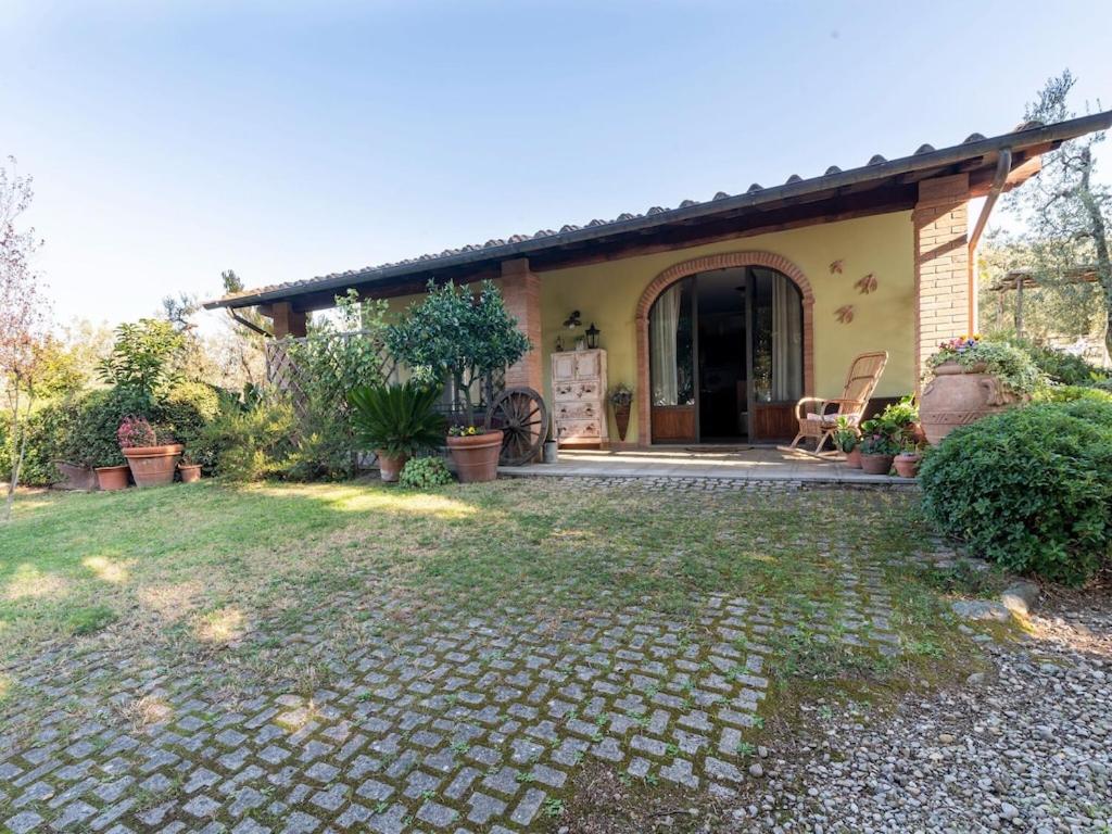 a house with a stone driveway in front of it at Blissful Tuscan Hideaway in Arezzo
