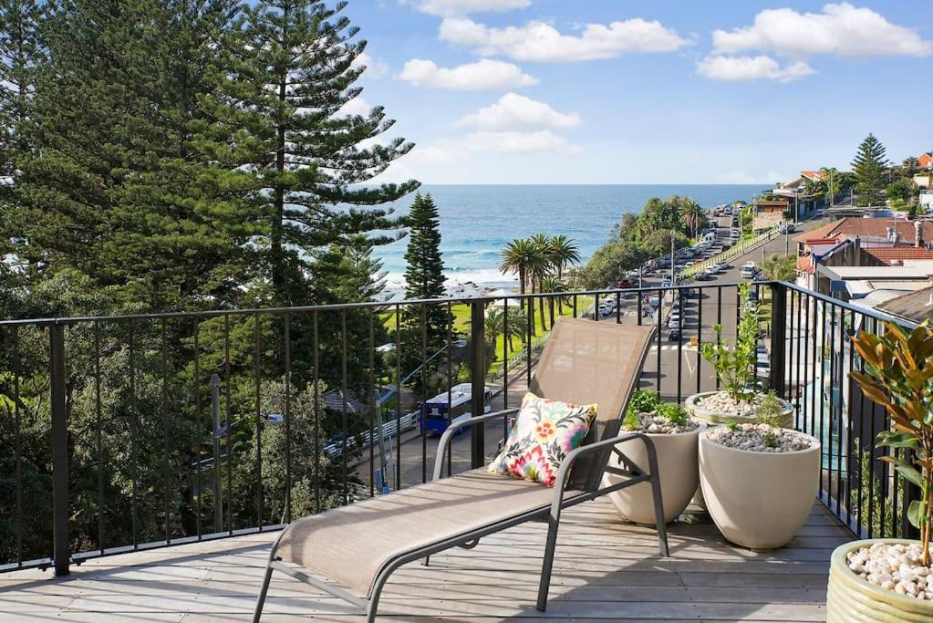 a balcony with a bench and a view of the ocean at BRON455B - Bronte Beach House with Ocean Views in Sydney