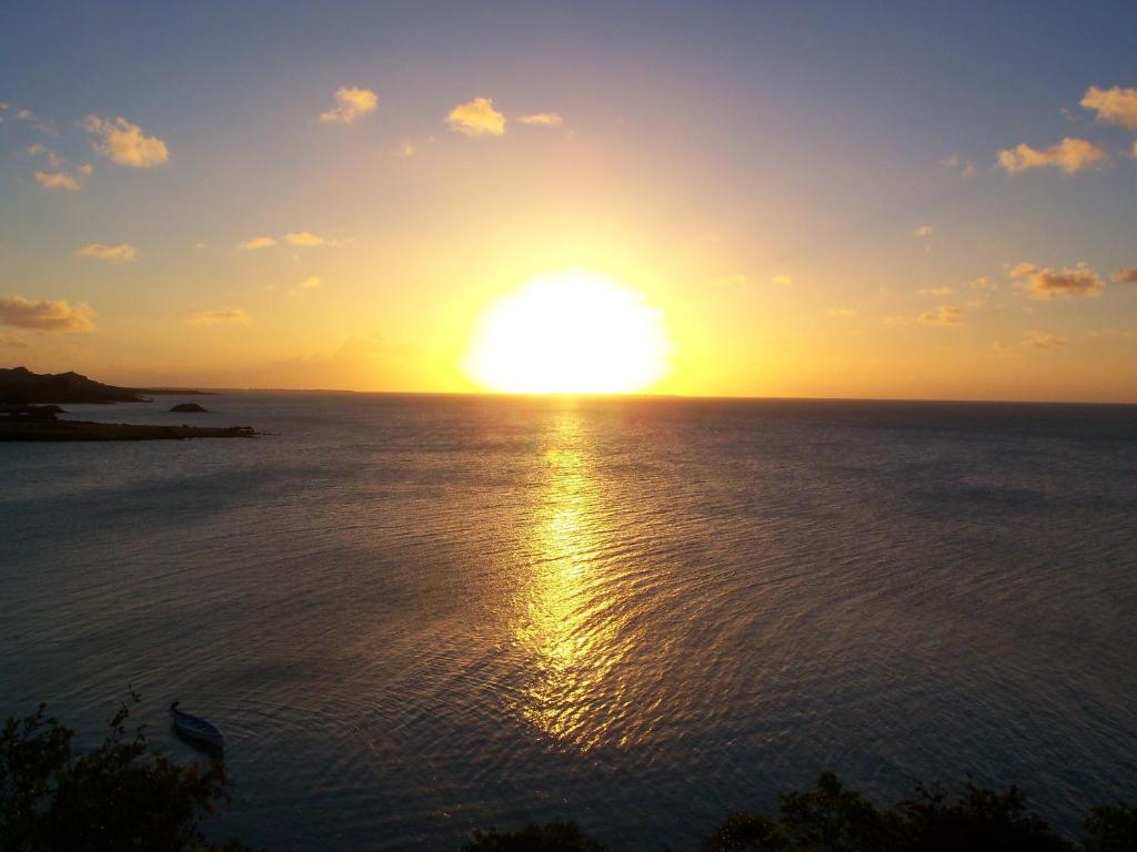 zachód słońca nad oceanem i słońce na niebie w obiekcie Villa Anse Goeland w mieście Rodrigues Island
