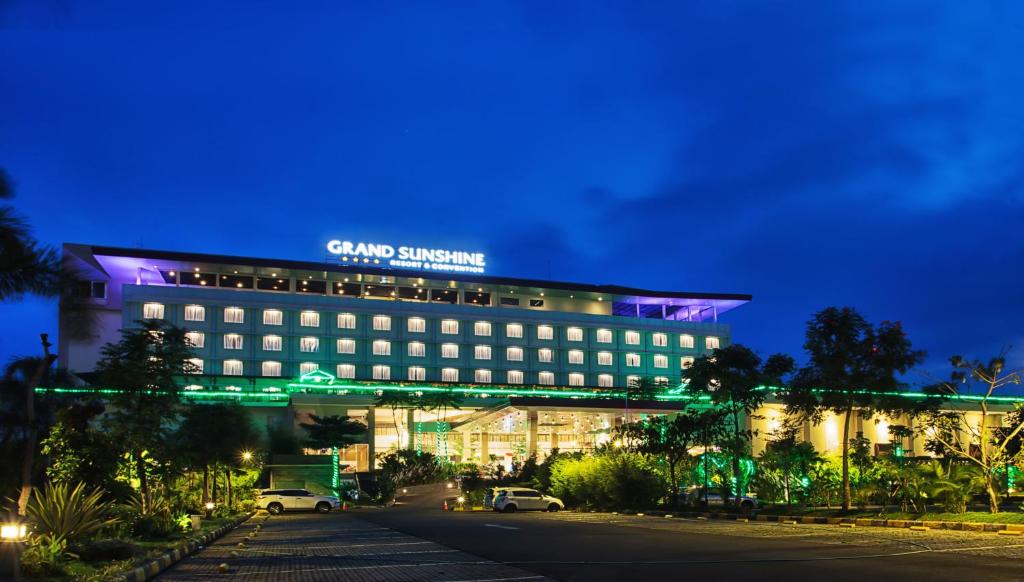 a building with a sign on top of it at night at Grand Sunshine Resort & Convention in Bandung