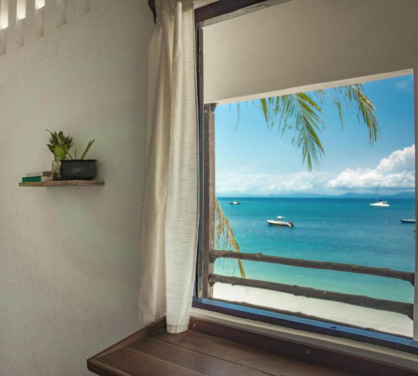a window with a view of the ocean at Chez Senga in Madirokely