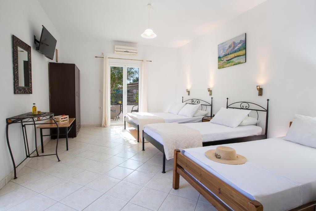 a living room with two beds and a table at Spacious Studios Lefkada Mountain View Near Beach in Dhráganon