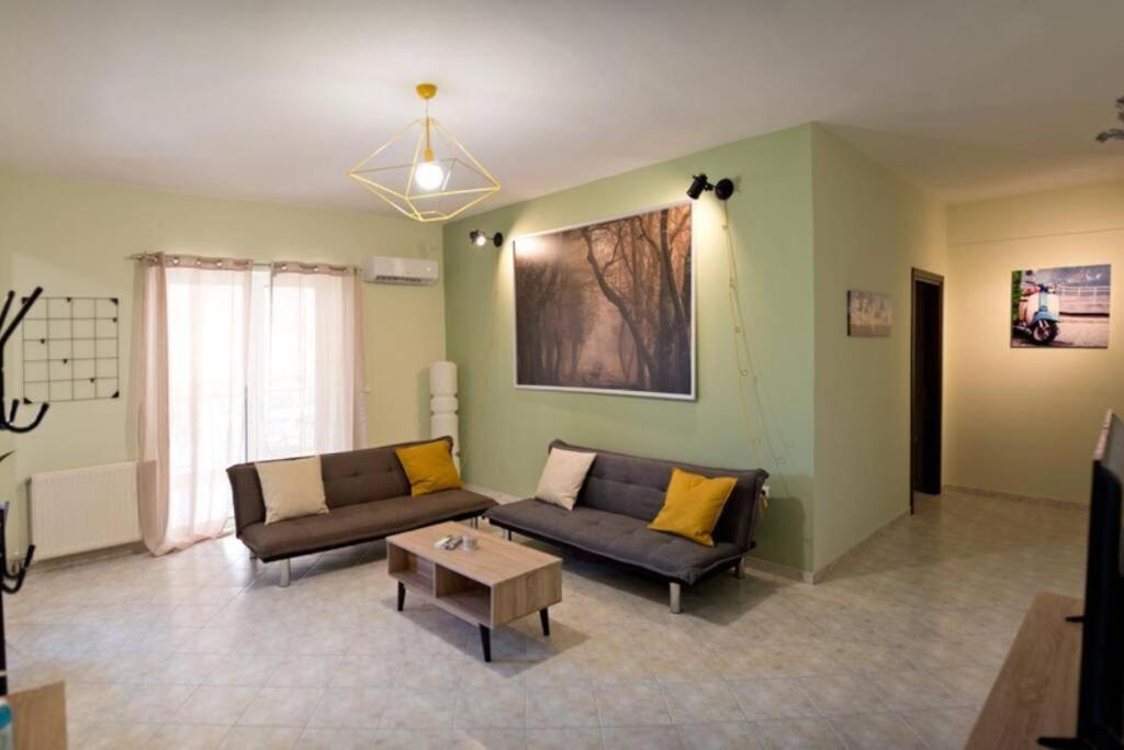 a living room with two couches and a coffee table at Chalkis Green Leaf House in Chalkida