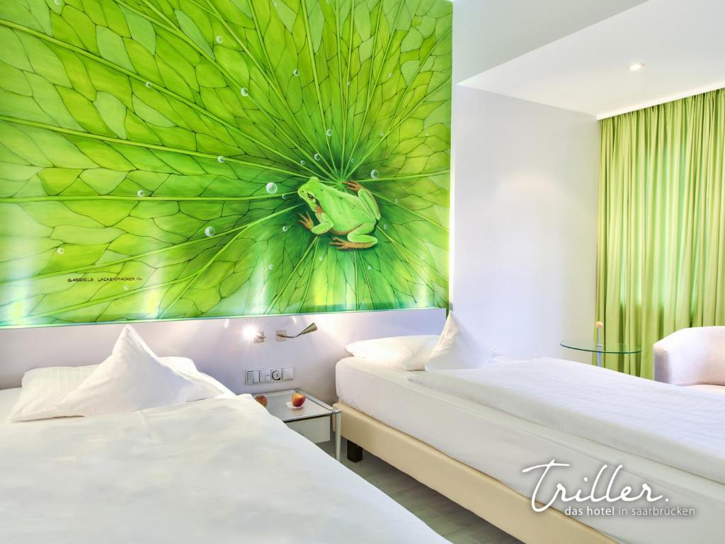 um quarto com duas camas e uma pintura de uma planta em Hotel Am Triller - Hotel & Serviced Apartments em Saarbrücken