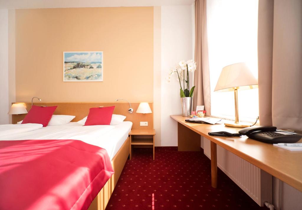 Postel nebo postele na pokoji v ubytování City-Hotel Am Wasserturm Halle