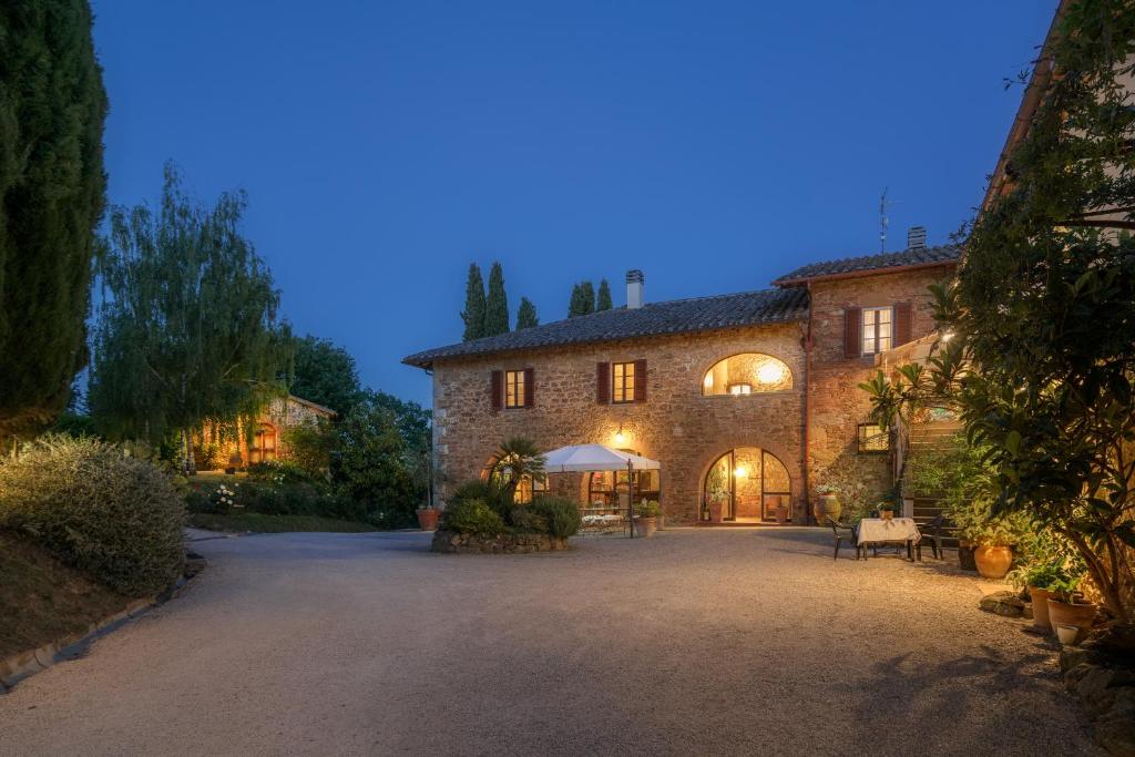 a large stone house with a large driveway at Agriturismo Renello in Petroio