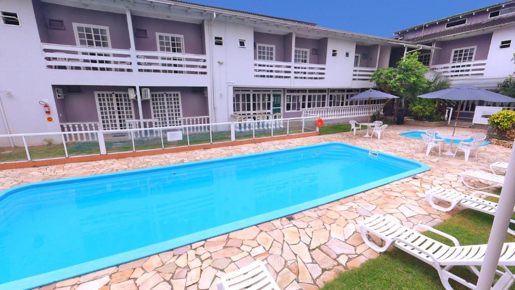 a large swimming pool in front of a building at Hotel Pousada Ilha do Mar Bombinhas in Bombinhas