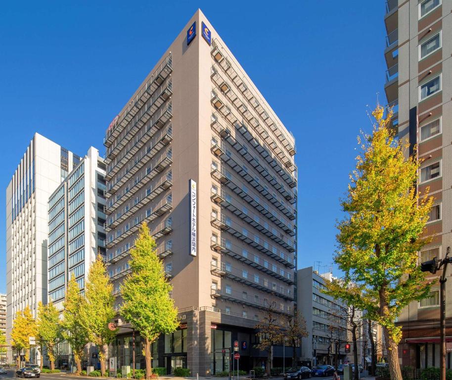 een hoog gebouw met een bord aan de zijkant bij Comfort Hotel Yokohama Kannai in Yokohama