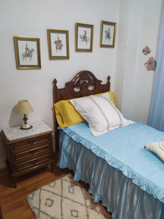 a bedroom with a bed and a table with a lamp at Josefa House in Huelva