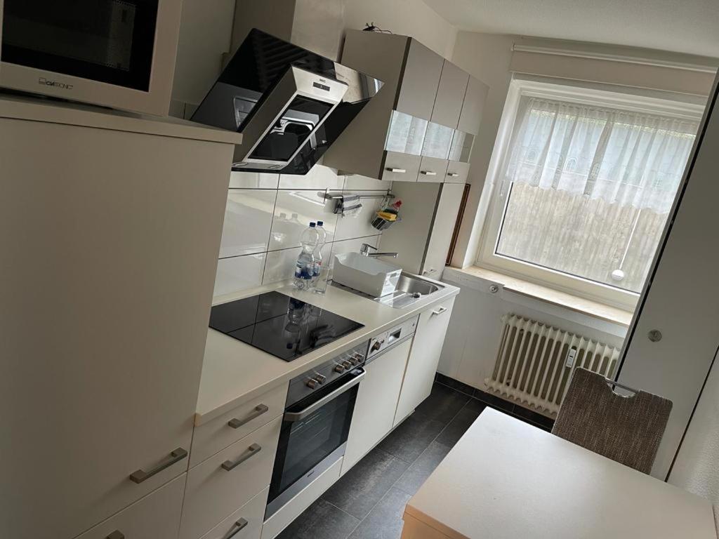 a kitchen with a sink and a stove top oven at Apartment Düsseldorf-Süd in Düsseldorf