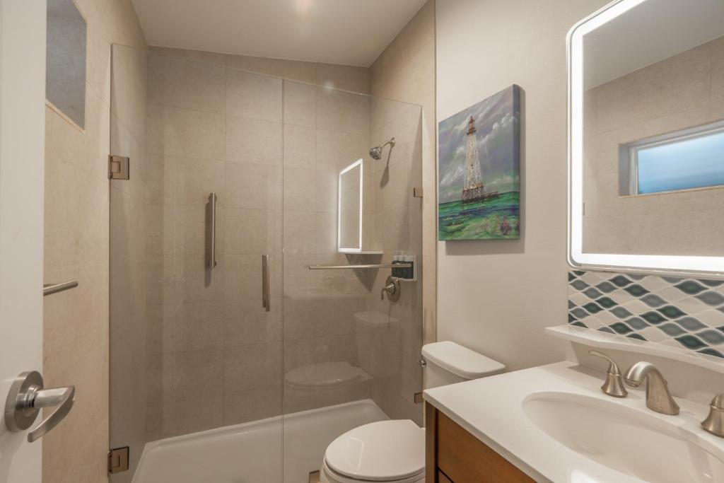 a bathroom with a shower and a toilet and a sink at Islander Resort in Islamorada
