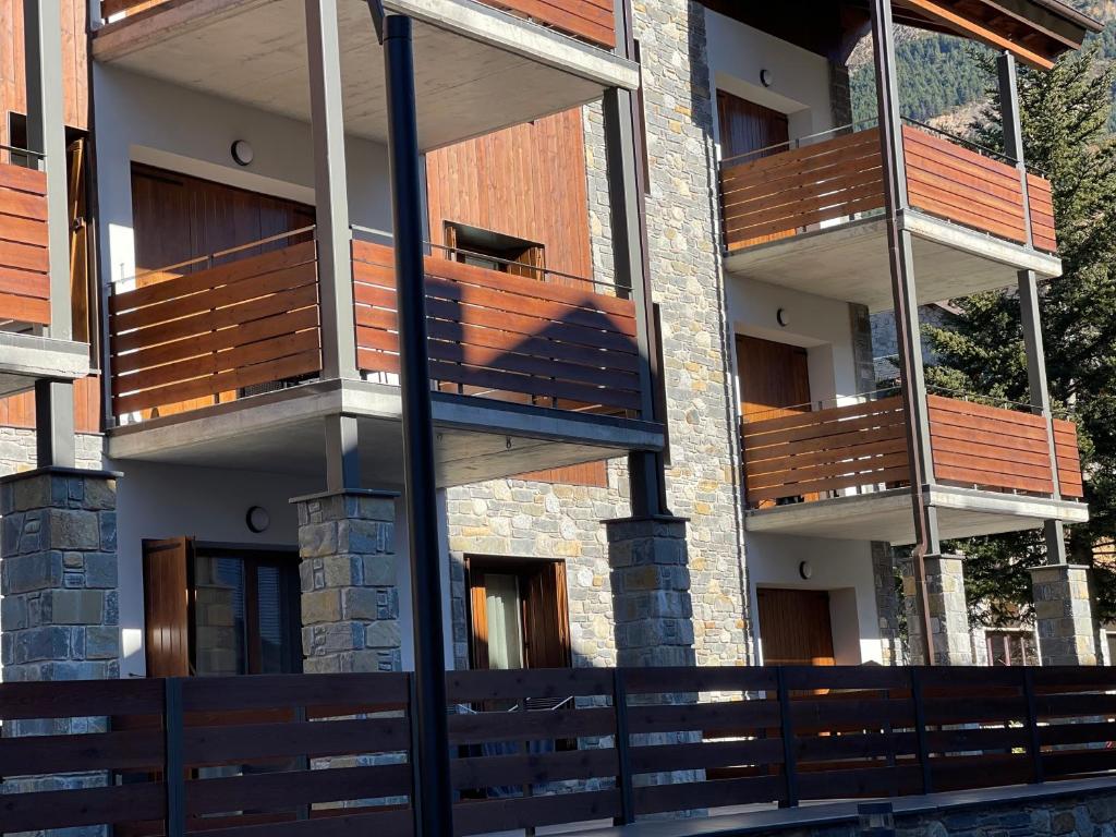a building with wooden balconies on the side of it at Blanchard Benas 2 in Benasque