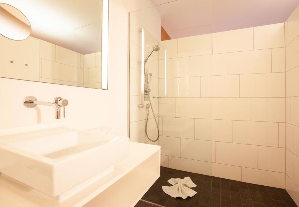 a white bathroom with a sink and a mirror at Bonawinkel NEU in Gaschurn