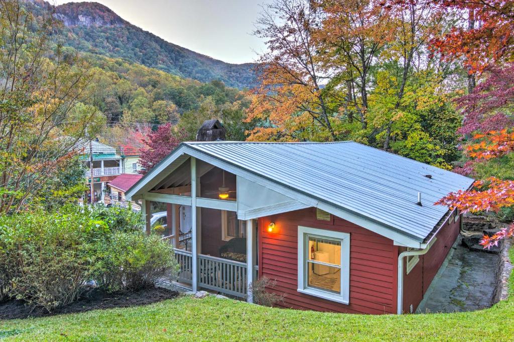 a small red house with a mountain in the background at Private and Cozy Chimney Rock Abode with Fire Pit in Chimney Rock