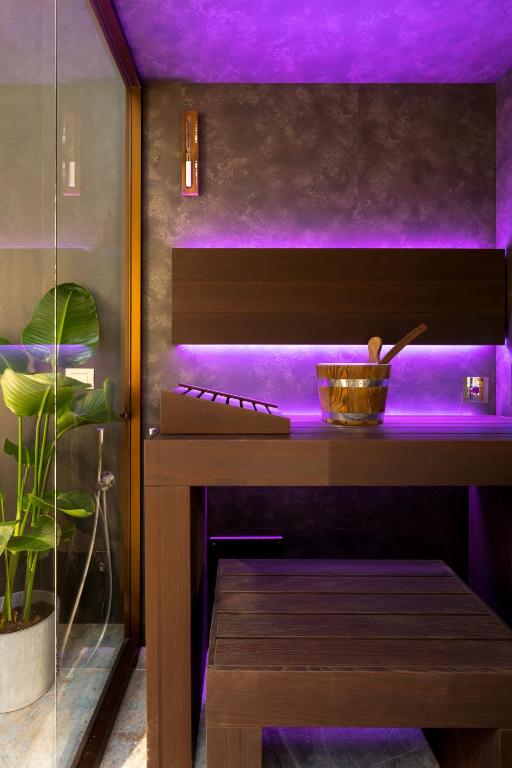 A bed or beds in a room at F1RST Suite Apartment & SPA