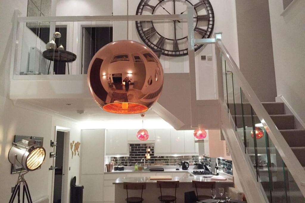 a kitchen with a large orb hanging from the ceiling at Spacious 1 Bedroom Split Level Old Pub Conversion Tower Bridge in London
