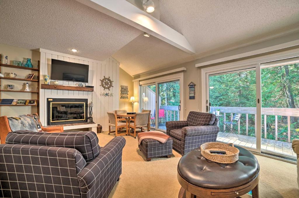 a living room with a couch and chairs and a fireplace at Cozy Family Home with Fireplace Less Than 1 Mi to Lake! in Harbor Springs