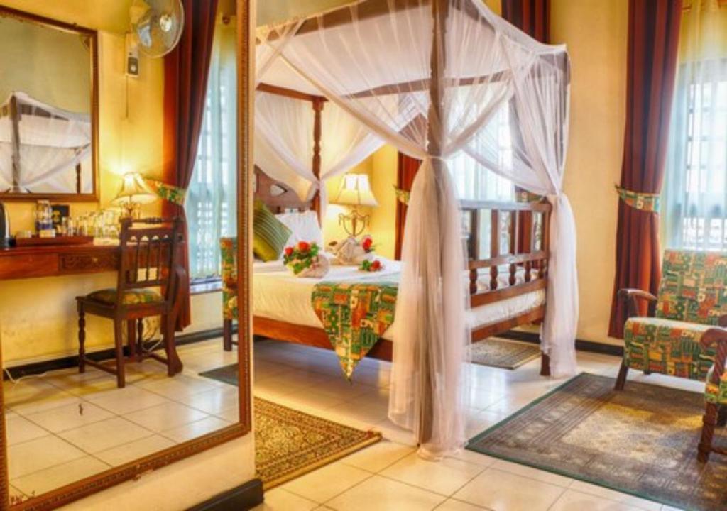 Africa House Zanzibar tesisinde bir odada yatak veya yataklar