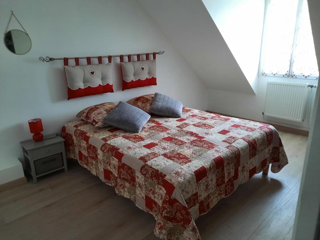 a bedroom with a bed with a quilt on it at La bellangerie in Joue-les-Tours
