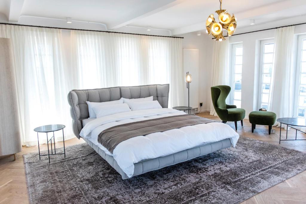 a bedroom with a large bed and a chandelier at Brands Loft in Hamburg